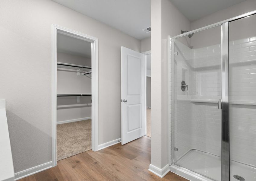 The master bathroom has a glass, walk-in shower.