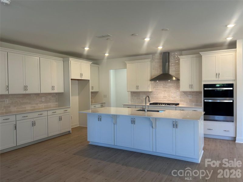 Spacious White Gournet Kitchen with Abundant Storage and Countertop Space