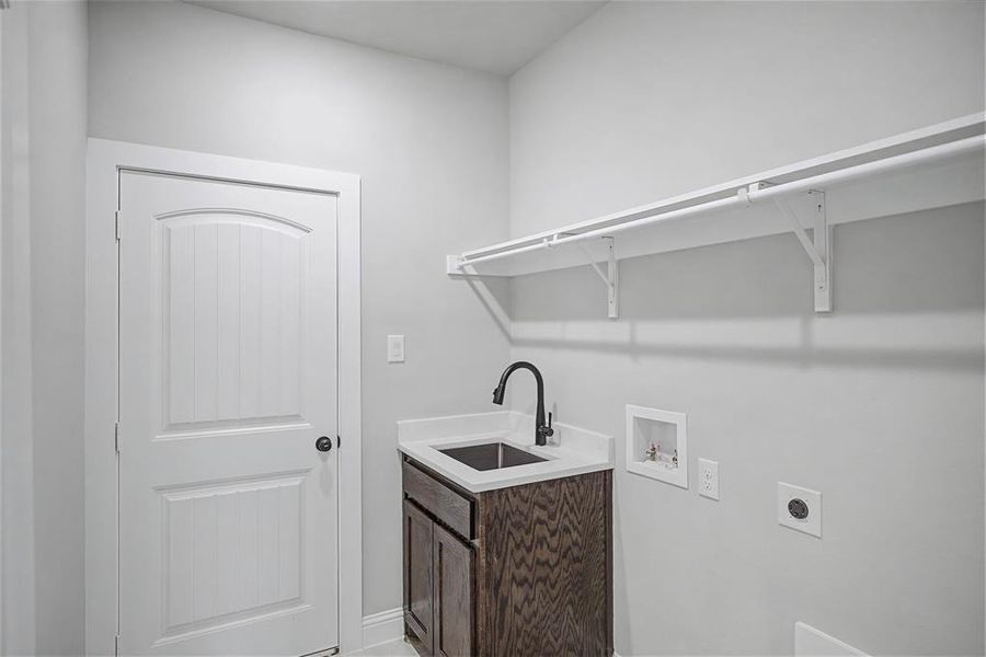 Laundry room with electric dryer hookup, washer hookup, and cabinet space
