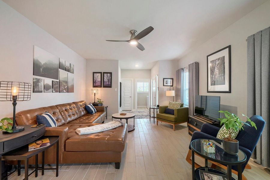 An inviting living area featuring light-toned flooring and a cozy seating arrangement. An inviting living area featuring light-toned flooring and a cozy seating arrangement.
