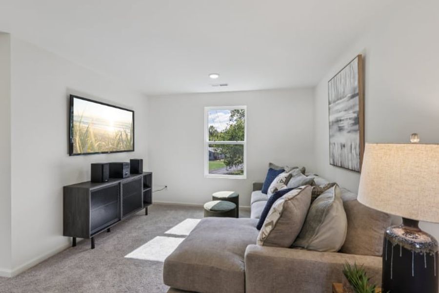A living room with a couch and a tv.