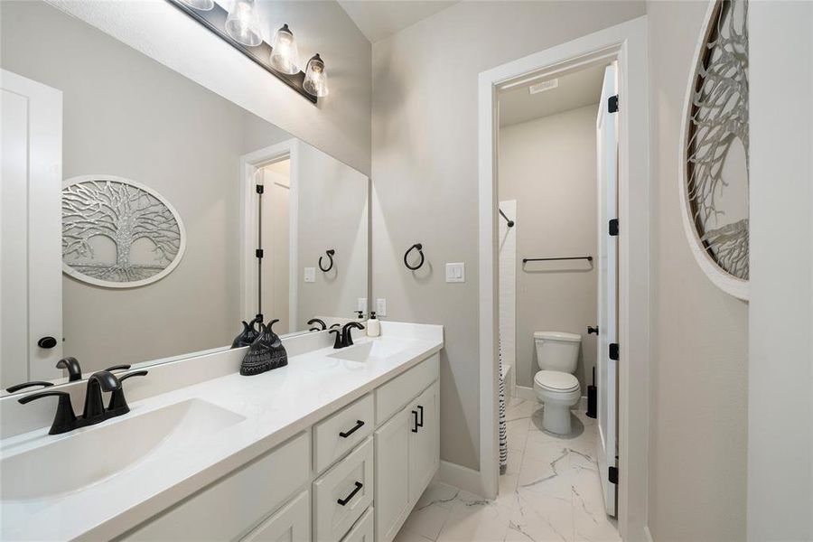 Bathroom featuring vanity and toilet