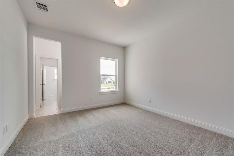 Spare room featuring carpet flooring