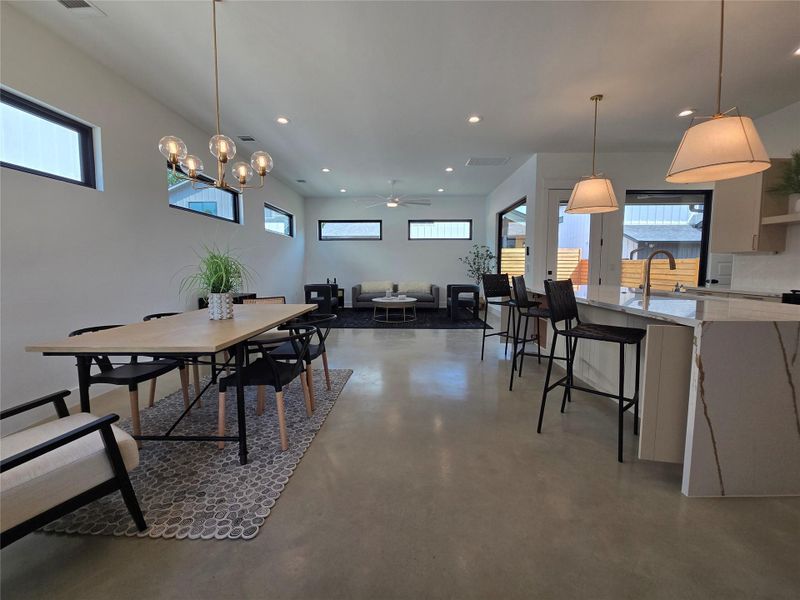Dining room featuring a wealth of natural light, concrete floors, and recessed lighting Dining room featuring a wealth of natural light, concrete floors, and recessed lighting