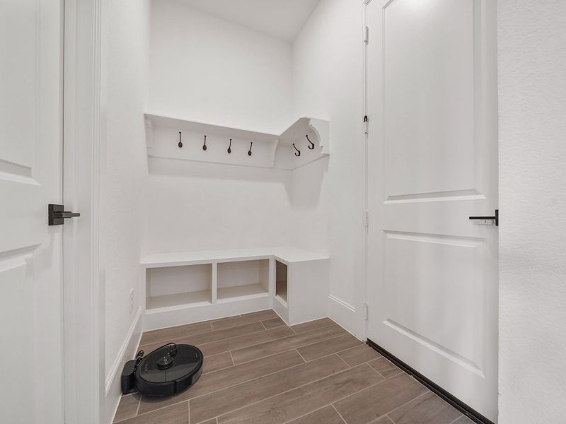The mudroom area provides an organized transition from the garage into the home. With built-in storage and thoughtful design, it keeps everyday essentials neat and out of sight while maintaining a polished look.
