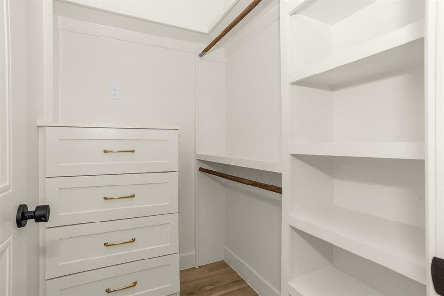 Walk in closet featuring dark wood-style flooring