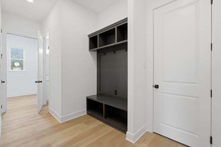 Mudroom with custom built in chelfing.