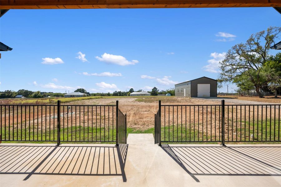 View of patio featuring an outbuilding, a garage, and driveway
