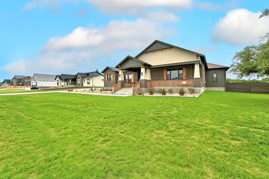 Craftsman house with covered porch and a front lawn