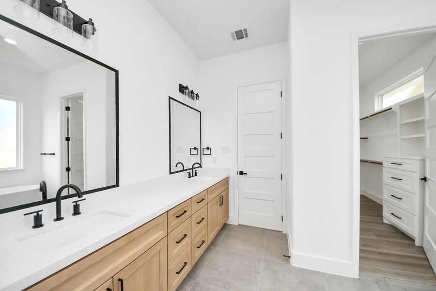 Primary bathroom w/ dual vanites. Primary bathroom w/ dual vanites.