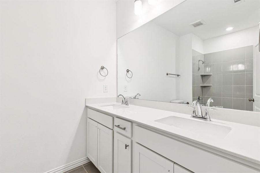 Friends and family will enjoy their own vanity space in this thoughtfully designed guest bath. Friends and family will enjoy their own vanity space in this thoughtfully designed guest bath.