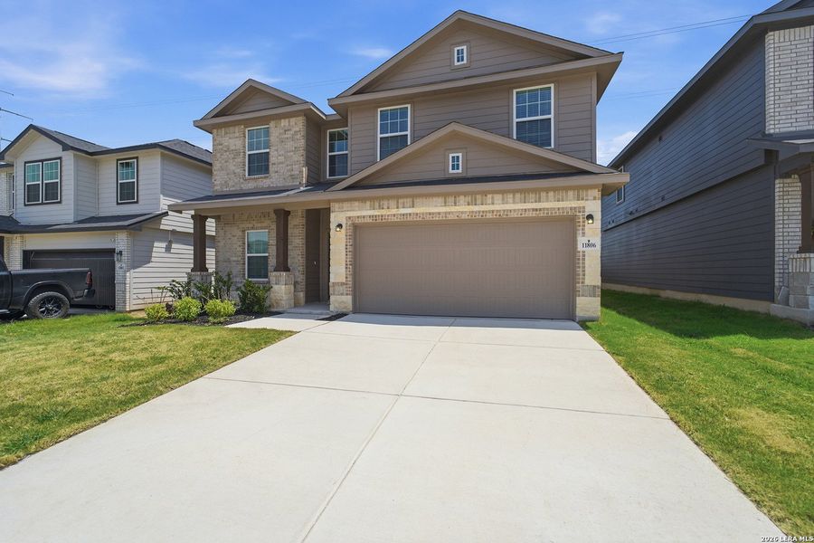 Front exterior of a new home in Laurel Vistas, San Antonio, TX, highlighting curb appeal (Image 20).