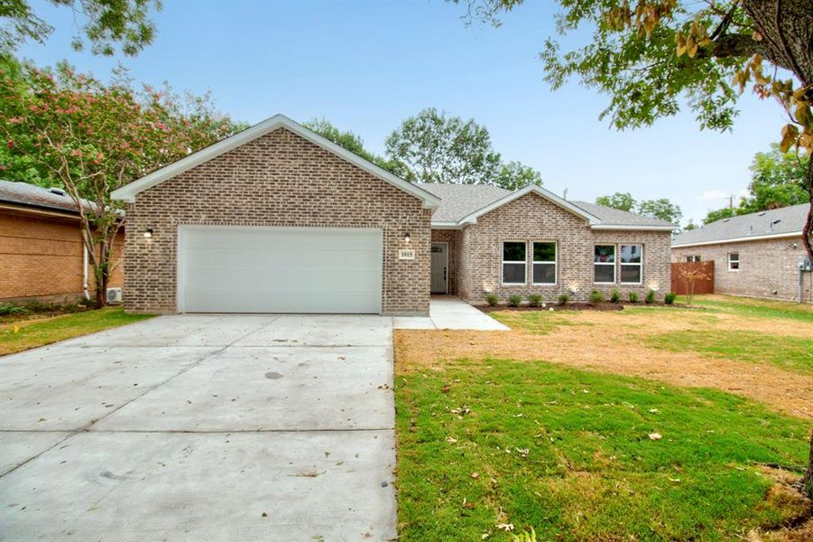 Ranch-style house featuring driveway, brick siding, a garage, and a front lawn Ranch-style house featuring driveway, brick siding, a garage, and a front lawn