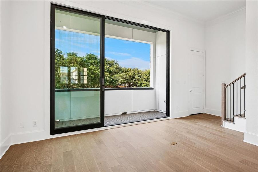 Sliding glass door opening to an outdoor balcony with a glass railing Sliding glass door opening to an outdoor balcony with a glass railing