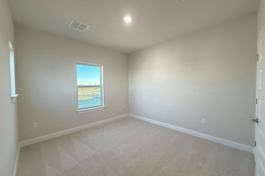 Unfurnished room with light colored carpet and baseboards