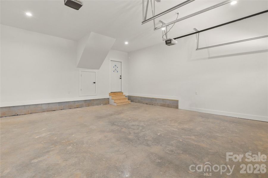 Fully finished over sized two car garage. There is also a storage area behing the small door that uses the space under the stairs