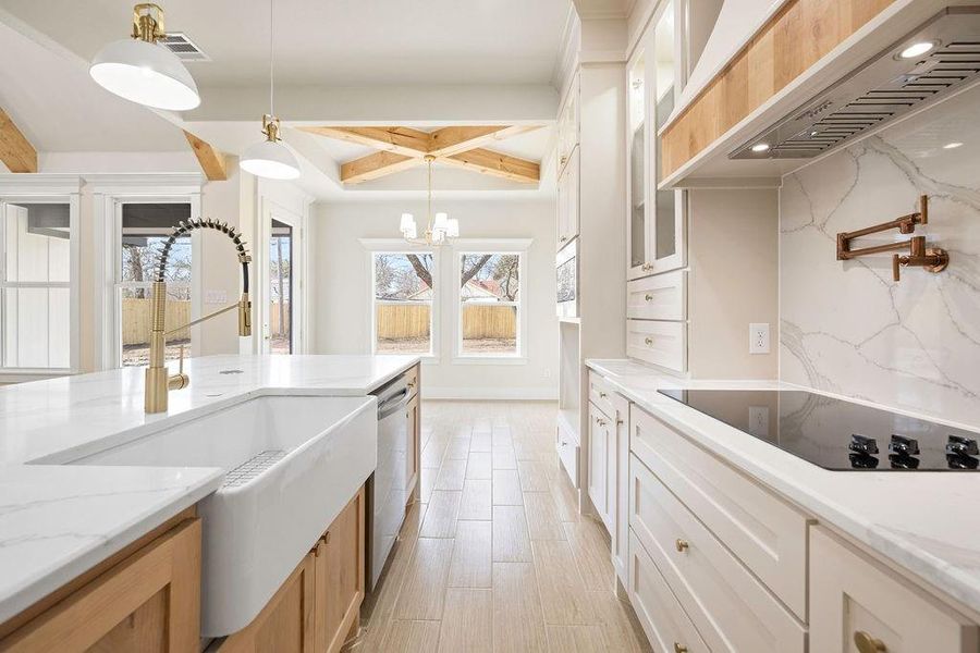 Kitchen with black electric stovetop, premium range hood, dishwasher, tasteful backsplash, and pendant lighting