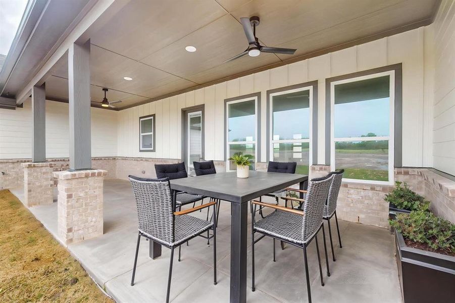 View of patio / terrace with a ceiling fan and outdoor dining area View of patio / terrace with a ceiling fan and outdoor dining area