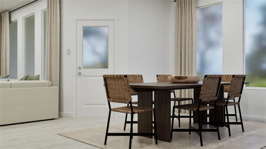 Dining room featuring light wood finished floors and baseboards