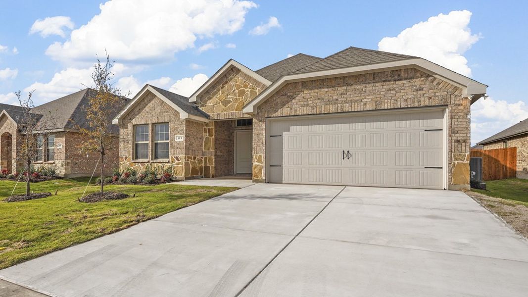 Front exterior of a new home in Trailstone, Caddo Mills, TX, highlighting curb appeal (Image 2). Front exterior of a new home in Trailstone, Caddo Mills, TX, highlighting curb appeal (Image 2).