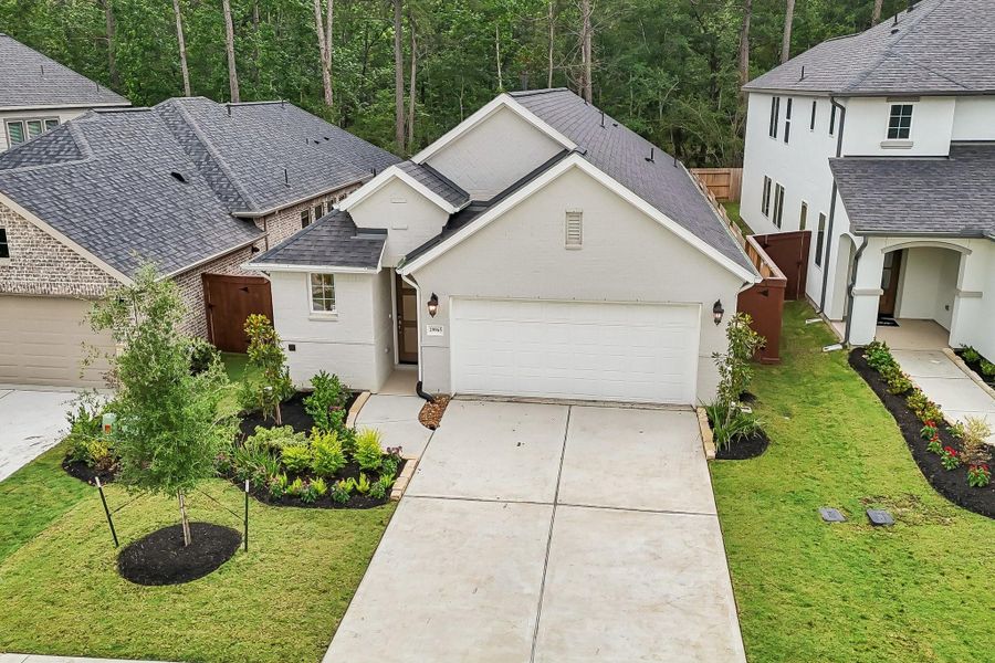 Front exterior of a new home in Woodhavyn 40', Magnolia, TX, highlighting curb appeal (Image 16). Front exterior of a new home in Woodhavyn 40', Magnolia, TX, highlighting curb appeal (Image 16).
