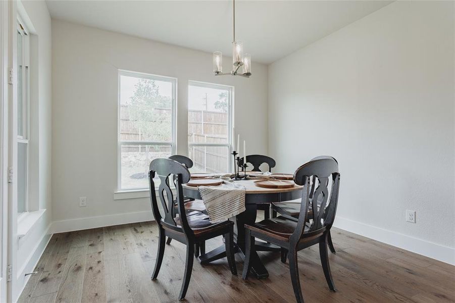 Dining area featuring wood-finish flooring, white baseboards, and neutral wall tones
