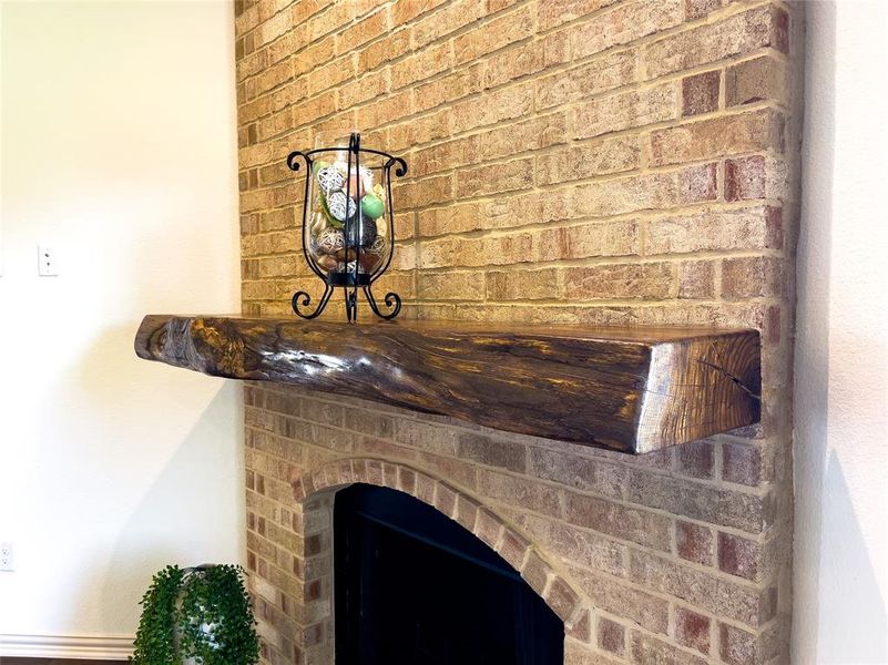 Fireplace with live-edge custom mantle - brick on fireplace will match exterior brick of project