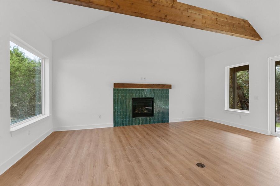 A striking fireplace with rich green tile anchors this naturally illuminated living space, complemented by a rustic exposed beam. A striking fireplace with rich green tile anchors this naturally illuminated living space, complemented by a rustic exposed beam.