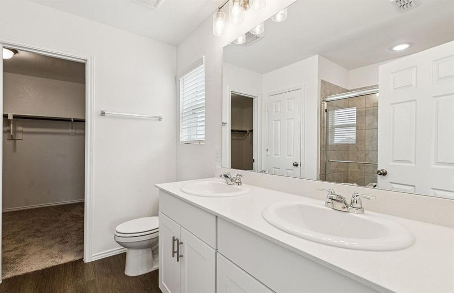 Modern owner's bath with dual vanities and a spacious shower *Real home pictured Modern owner's bath with dual vanities and a spacious shower *Real home pictured