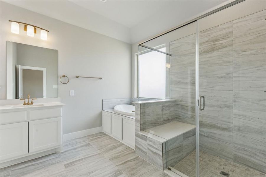 Bathroom with vanity, tile patterned flooring, and plus walk in shower