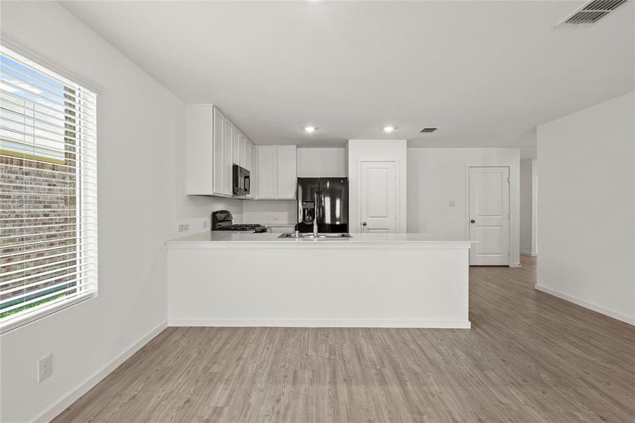 Open-concept living space with wood-finish flooring