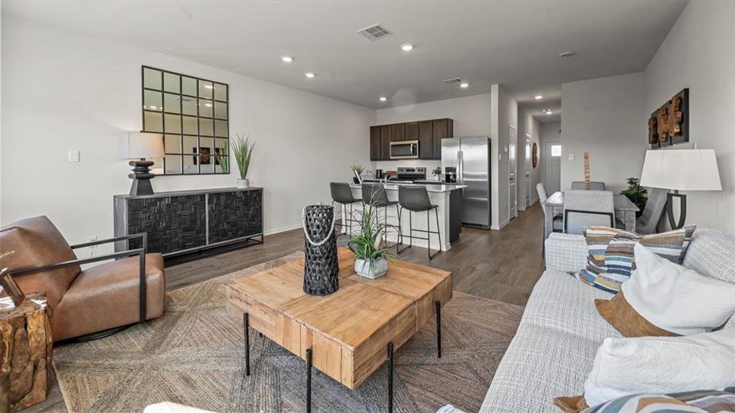 Living area featuring dark wood-style floors and recessed lighting