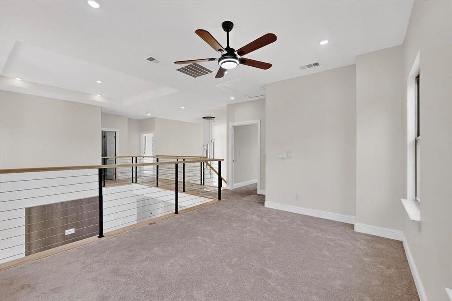 Spare room featuring light carpet, a ceiling fan, recessed lighting, a raised ceiling, and attic access Spare room featuring light carpet, a ceiling fan, recessed lighting, a raised ceiling, and attic access