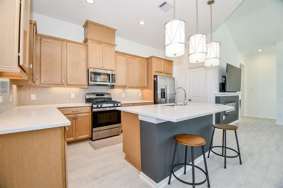 This island kitchen offers ample cabinetry and countertop space plus a large pantry. You'll have plenty of space for all your favorite kitchen gadgers here!