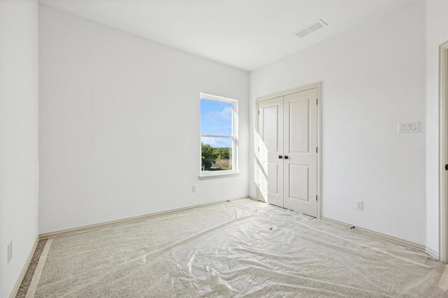 Empty room with light colored carpet