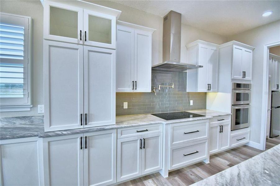 Beautiful Cabinetry with Range Hood and Pot Filler