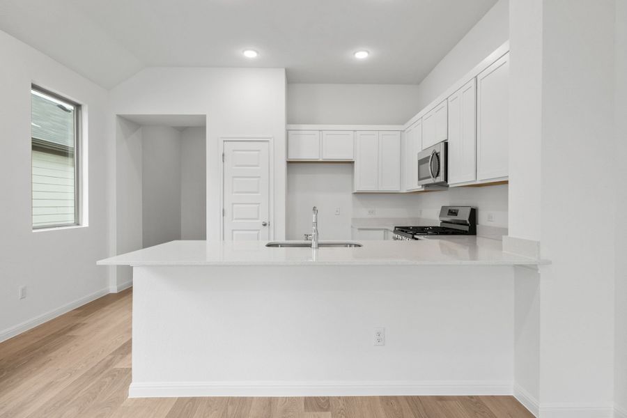 Kitchen in the Birch home plan by Trophy Signature Homes – REPRESENTATIVE PHOTO