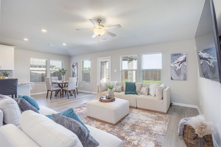Living area featuring light wood-style floors, ceiling fan, and recessed lighting Living area featuring light wood-style floors, ceiling fan, and recessed lighting