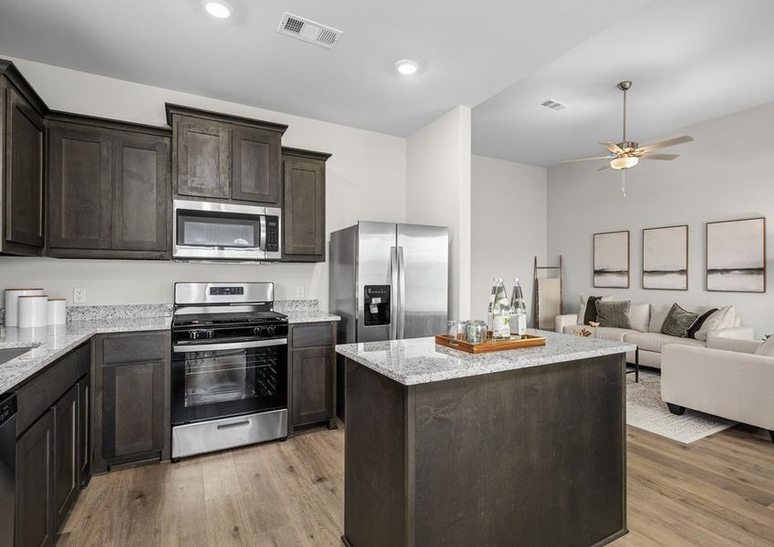 The kitchen has beautiful wood cabinetry.