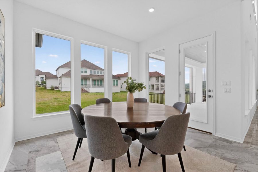 Bright interior space featuring multiple windows, a full-lite door, recessed lighting, and large format tile flooring