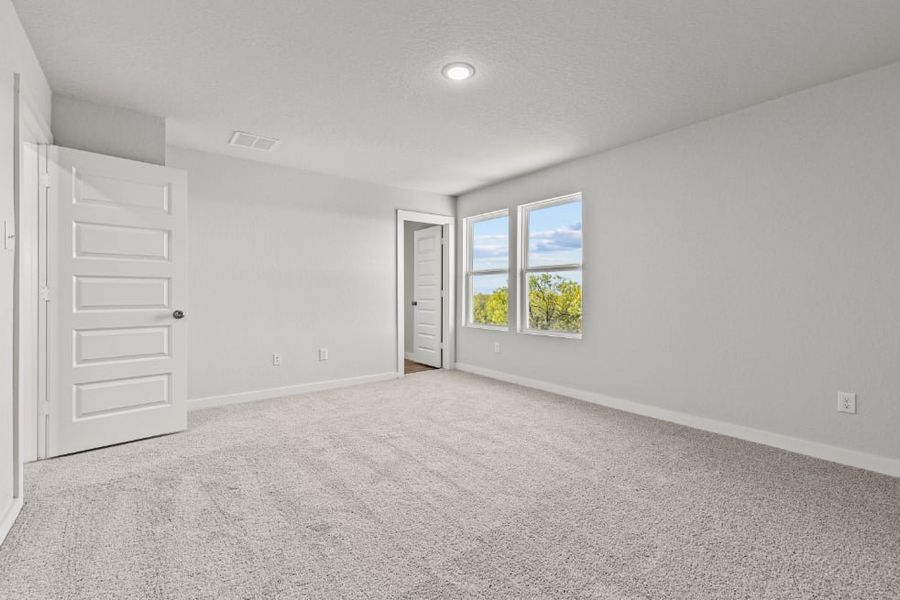 A room with white walls and a window.