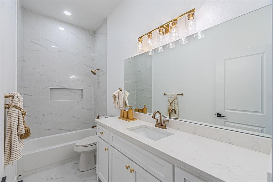 Bathroom with vanity, shower / bath combination, light marble finish flooring, and recessed lighting