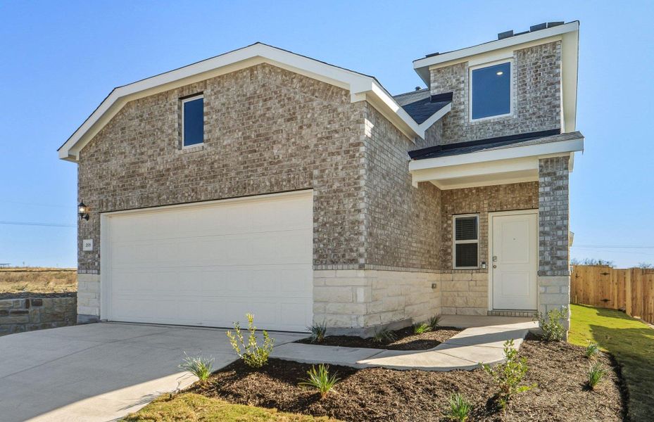Front exterior of a new home in Sunfield, Buda, TX, highlighting curb appeal (Image 2). Front exterior of a new home in Sunfield, Buda, TX, highlighting curb appeal (Image 2).