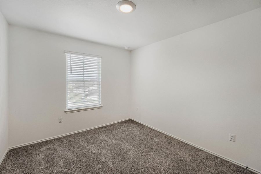 Bedroom #2 featuring light gray carpeting, white walls, a single window with blinds, and a flush-mount ceiling light Bedroom #2 featuring light gray carpeting, white walls, a single window with blinds, and a flush-mount ceiling light