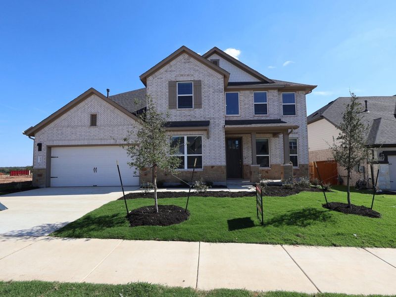 Front exterior of a new home in Edgewood, Leander, TX, highlighting curb appeal (Image 2). Front exterior of a new home in Edgewood, Leander, TX, highlighting curb appeal (Image 2).