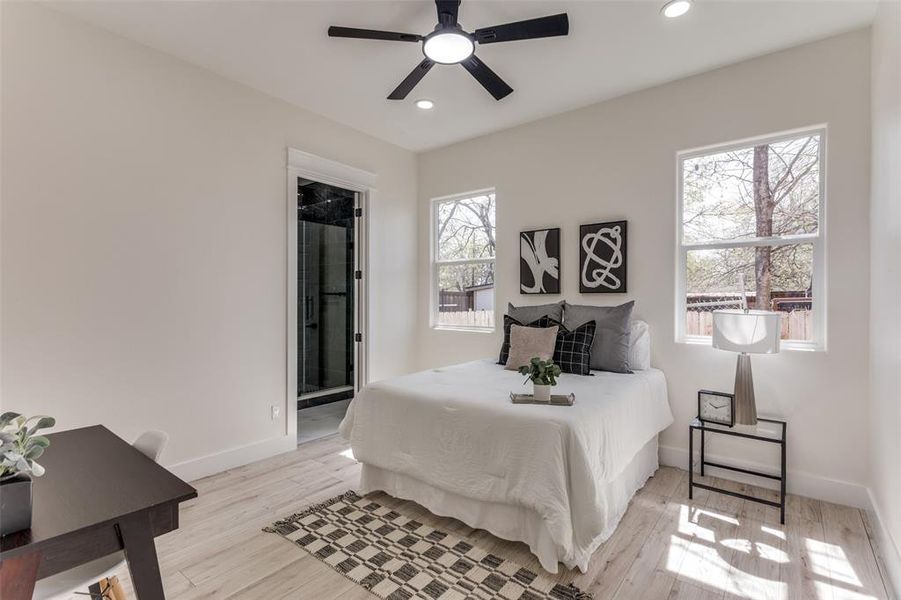 Bedroom with a ceiling fan, baseboards, light wood finished floors, recessed lighting, and connected bathroom