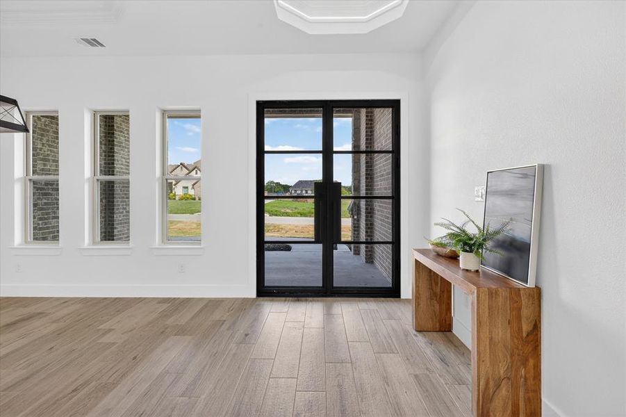 Doorway featuring wood finished floors and baseboards