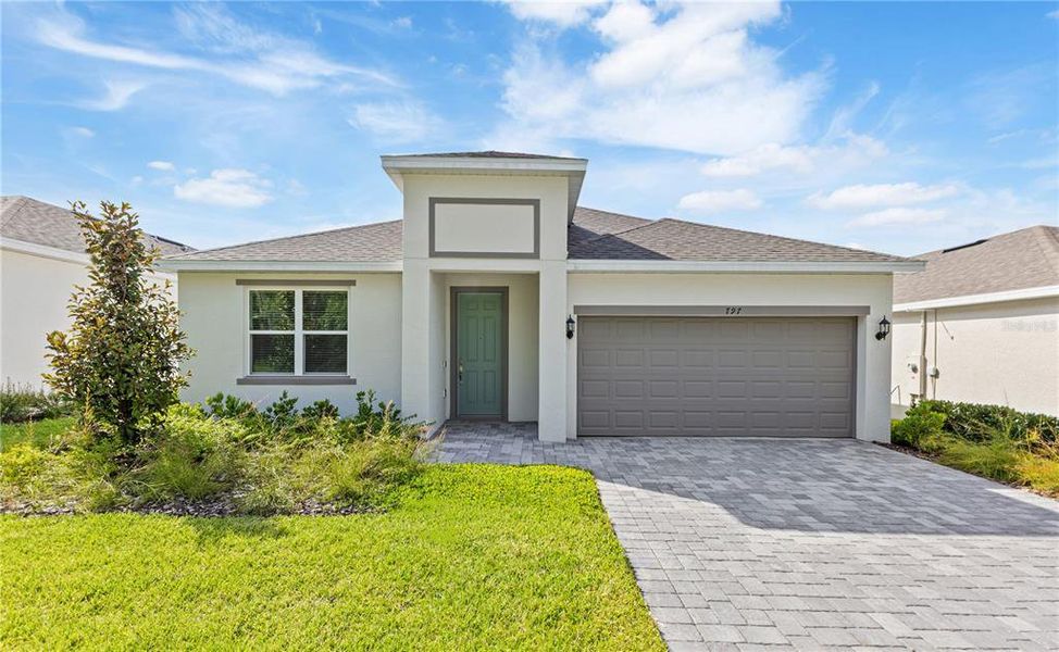 Front exterior of a new home in Mirror Lake Village, Fruitland Park, FL, highlighting curb appeal (Image 1).