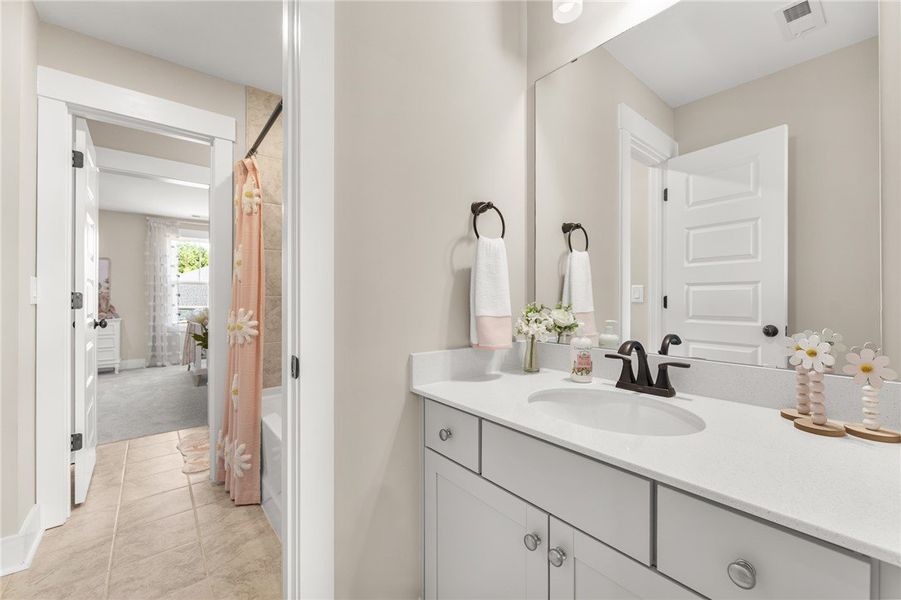 This bright bathroom features a spacious vanity wi