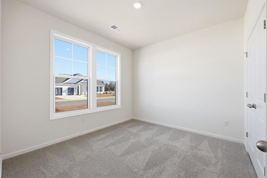Spare room with light carpet and recessed lighting
